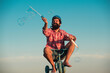 © Volodymyr - Childhood memory. Portrait of a bearded man as a crazy hipster having fun with bicycle outdoors.