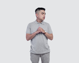 Young handsome man wearing grey polo shirt isolated on background