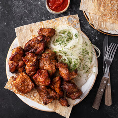 Wall Mural - Grilled sashlik meat on a plate. Barbecue pork meat. Top view