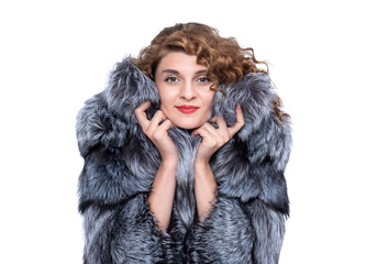 portrait of a young pretty happy woman in a silver fox fur coat. isolated on white background.