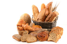 Wicker Basket With Selection Of Breads And Pastries Isolated On White Background