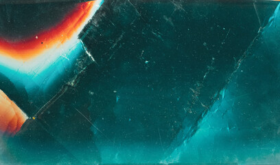 Wall Mural - Fractured ice background. Shattered glass texture. Teal blue scratched crystal with orange glow.