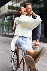 Wall Mural - close up of loving couple having fun and riding on bike in the city