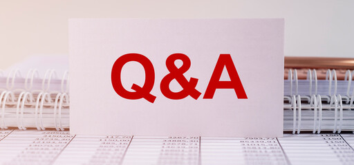 Q and A - Questions and Answers text on business white card on office table, banner