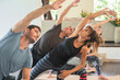 © Space_Cat - Group of diverse multiethnic people learning yoga class with teacher. Sporty men and women practicing Extended Side Angle Pose- Utthita Parsvakonasana. Healthy lifestyle and wellness