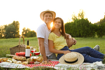 Canvas Print - Happy couple having picnic in park on sunny day