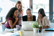© nenetus - Four beautiful smart business women work with laptops on the desk in the coworking space in the office.