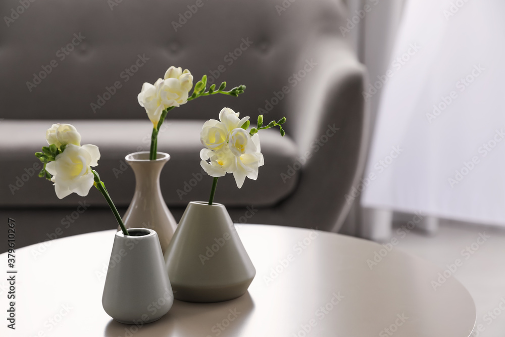Beautiful spring freesia flowers on white table in room - obrazy, fototapety, plakaty 