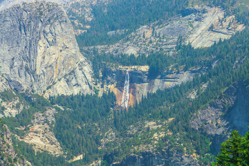 Nevada Fall waterfall panorama from the Glacier Point lookout in Yosemite National Park, California, United States of America. Glacier Point view of Liberty Cap and Nevada waterfall in Yosemite Valley