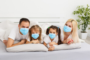 family in protective masks quarantined. Normal life with coronavirus. Lifestyle COVID-19. Quarantine virus protection. christmas