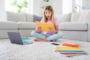 Canvas Print - Full size photo of astonished pupil sit floor legs crossed folded barefoot carpet read interesting encyclopedia impressed study remote in house indoors