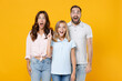 © ViDi Studio - Shocked young parents mom dad with child kid daughter teen girl in basic t-shirts hold index finger up with great new idea isolated on yellow background studio portrait. Family day parenthood concept.
