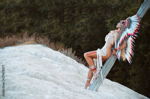 Plakat a woman in the image of the indigenous peoples of America posing Nude in nature
