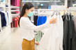 © tonefotografia - Woman wearing protective mask shopping under Covid-19 pandemic in shopping mall, social distancing protocol, New normal concept.
