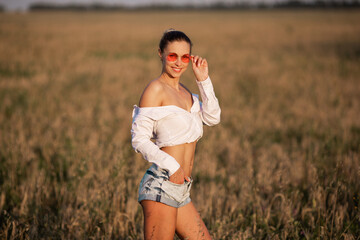 Wall Mural - beautiful young woman in pink glasses in summer