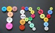 © Wendy - A closeup view of colourful buttons on a black background spelling the word 'TRY'.