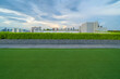 © tampatra - Sky garden on private rooftop of condominium or hotel, high rise architecture building with tree, grass field, and blue sky.