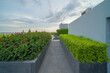 © tampatra - Sky garden on private rooftop of condominium or hotel, high rise architecture building with tree, grass field, and blue sky.