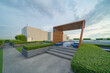 © tampatra - Sky garden on private rooftop of condominium or hotel, high rise architecture building with tree, grass field, and blue sky.