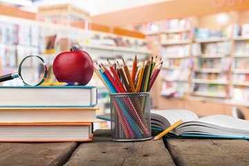 Wall Mural - Stack of vintage books and colorful pencils on the desk