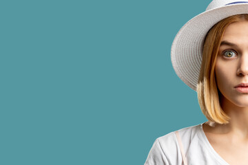 Summer holiday. Canceled vacation. Surprised blonde woman in white hat looking at camera isolated on blue copy space. Travel offer. Advertising background