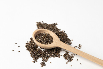 Wall Mural - Superfood concept with chia seeds in wooden spoon on white background.