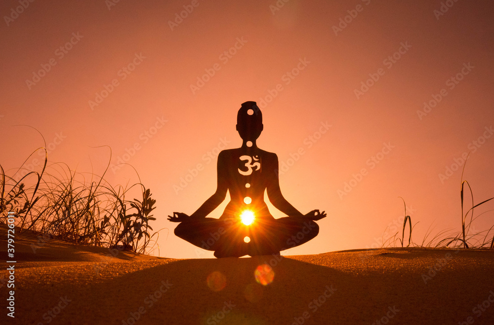 Silhouette of a person doing yoga with the root chakra symbol - obrazy, fototapety, plakaty 