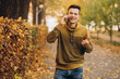 © anatoliycherkas - Portrait of handsome and happy guy smiling and talking on the phone in the autumn park
