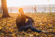 © anatoliycherkas - Portrait of handsome and happy guy smiling and talking on the phone in the autumn park