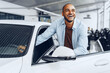 © fotofabrika - Portrait of a handsome happy African American man sitting in his newly bought car