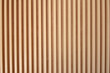 Light brown slats of wood. Lines of wooden slats form a striped texture pattern. Line shaped wood texture