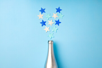 Festive background with champagne bottle and confetti