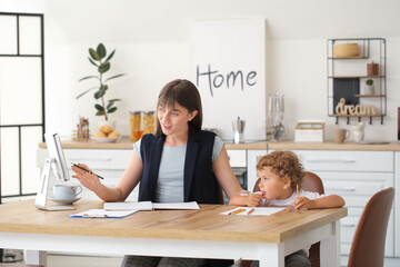 Sticker - Working mother with little son in kitchen at home