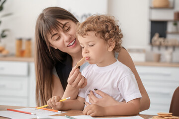 Sticker - Working mother with little son in kitchen at home