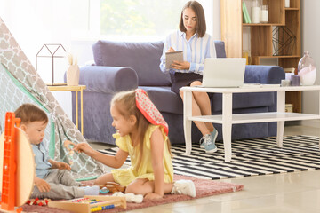 Poster - Working mother with little children at home