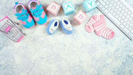 Wall Mural - Baby nursery clothing mom bloggers desktop workspace with accessories and shopping cart on white textured background. Top view blog hero header creative composition flat lay. Negative copy space.