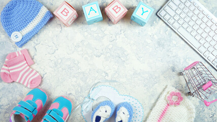 Wall Mural - Baby nursery clothing mom bloggers desktop workspace with accessories and shopping cart on white textured background. Top view blog hero header creative composition flat lay. Negative copy space.