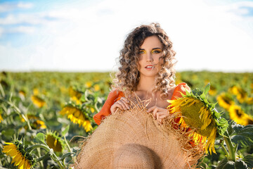 Sticker - Beautiful young woman in sunflower field