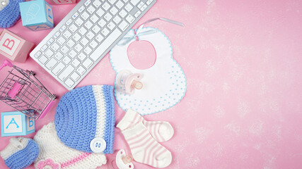 Wall Mural - Baby nursery clothing mom bloggers desktop workspace with pink and blue accessories on stylish pink textured background. Top view blog hero header creative composition flat lay. Negative copy space.