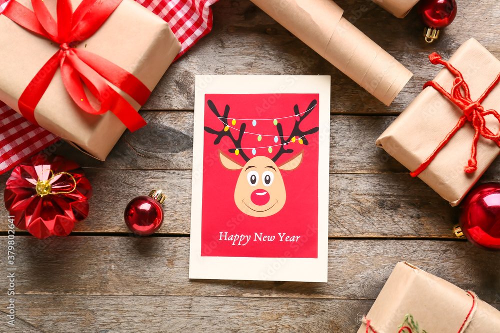 Beautiful composition with New Year greeting card on wooden background