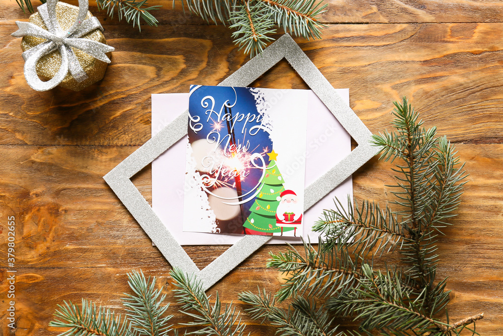 Beautiful composition with New Year greeting card on wooden background