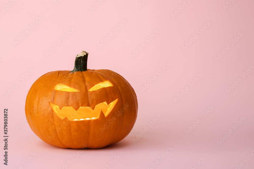 Carved Halloween pumpkin on color background
