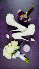 Wall Mural - Wedding bridal theme desktop workspace with high heel shoes, bouquets and accessories on vintage purple textured background. Top view blog hero header creative composition flat lay.