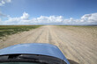 © Marcel/Stocksy - Driving a car on the beach