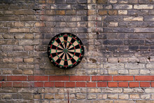 Classic Darts Board On Brick Wall