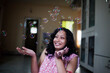 © Dream Lover/Stocksy - Young woman making fun with bubbles