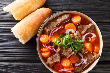 Wall Mural - Bo Kho recipe this Vietnamese beef stew has all the flavors of a traditional beef stew with additional aromatics from lemongrass and star anise closeup in bowl. Horizontal top view