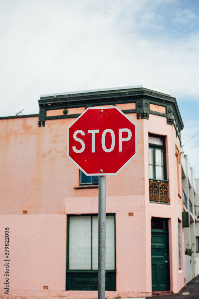 Stop Buildign Sign Stop sign in front of pink building Stock Photo | Adobe Stock