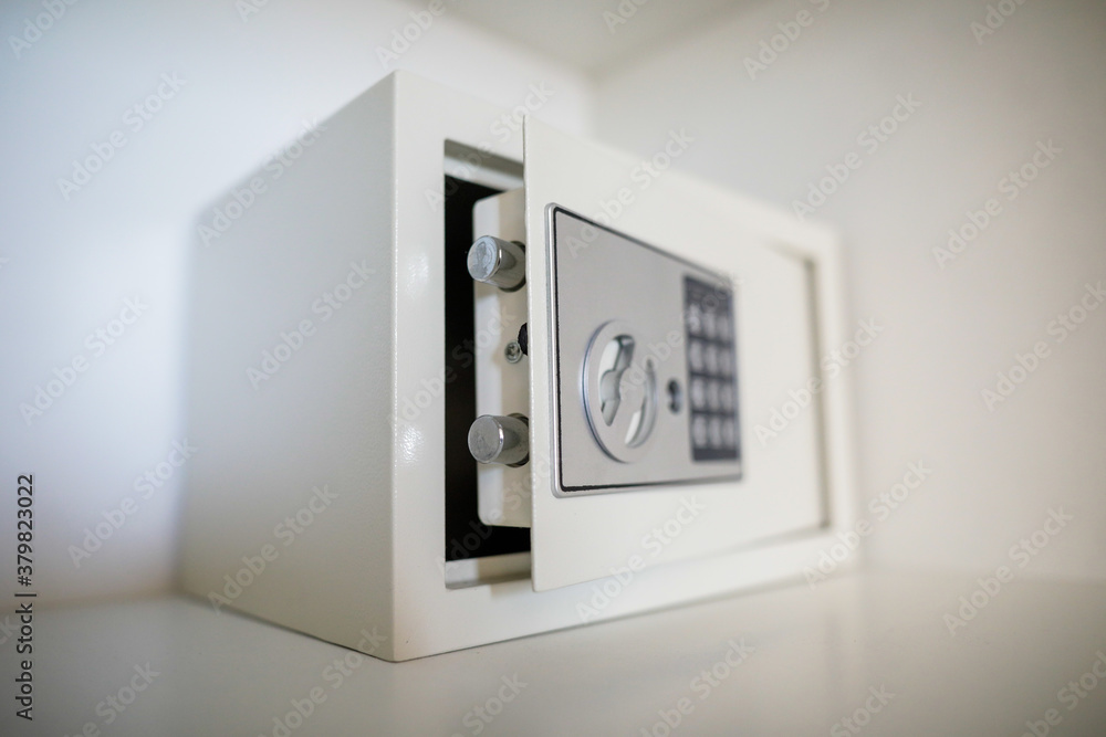 Metal safe inside an empty wooden closet in a hotel room - obrazy, fototapety, plakaty 