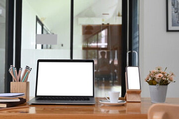 Office desk with laptop, smartphone white isolated screen and office supplies.